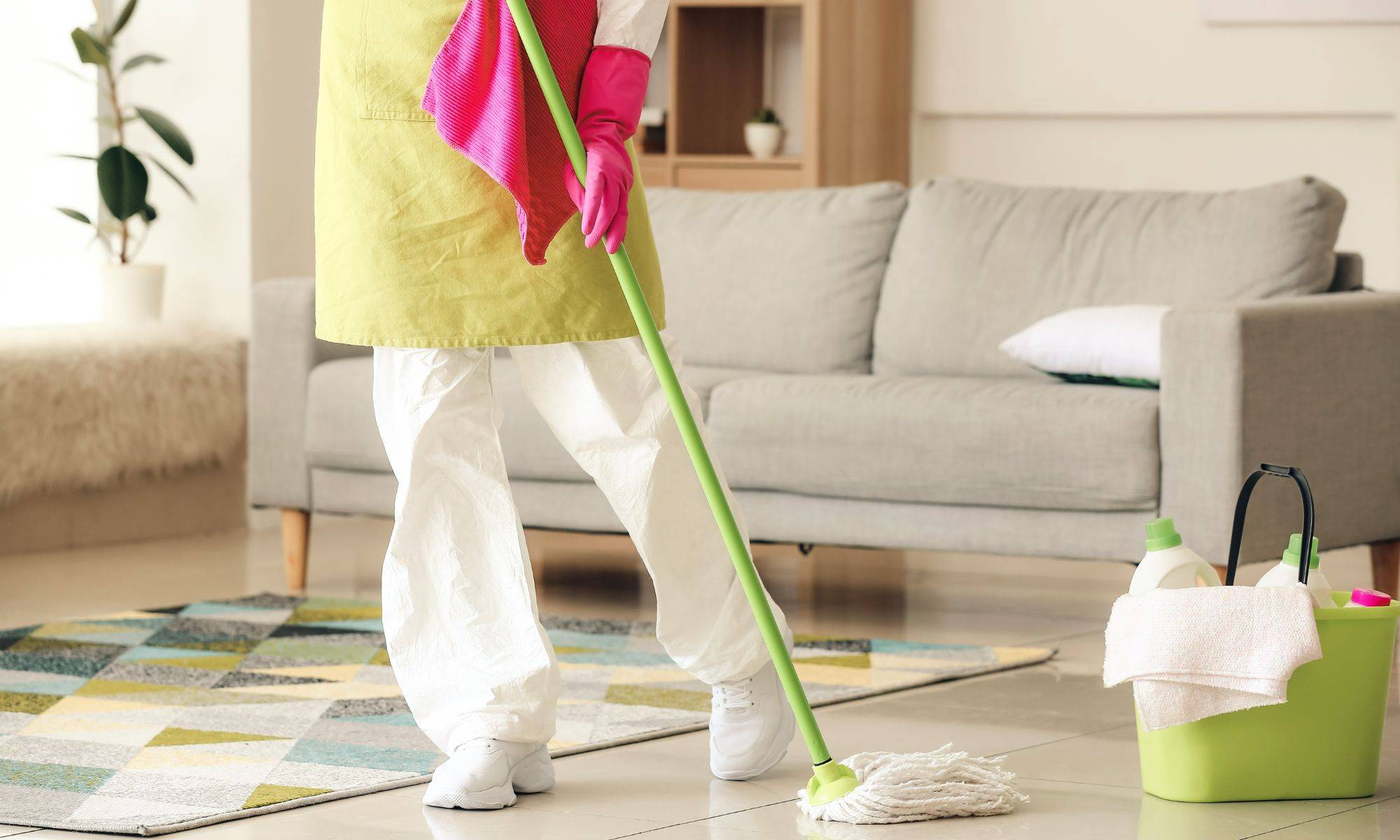 Housewife In Protective Costume Cleaning Floor In Room