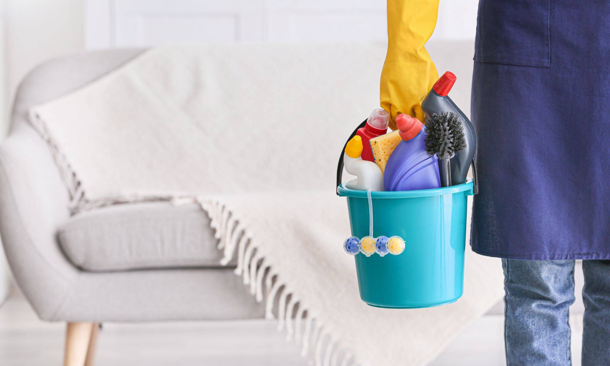 Janitor With Set Of Cleaning Supplies In Room